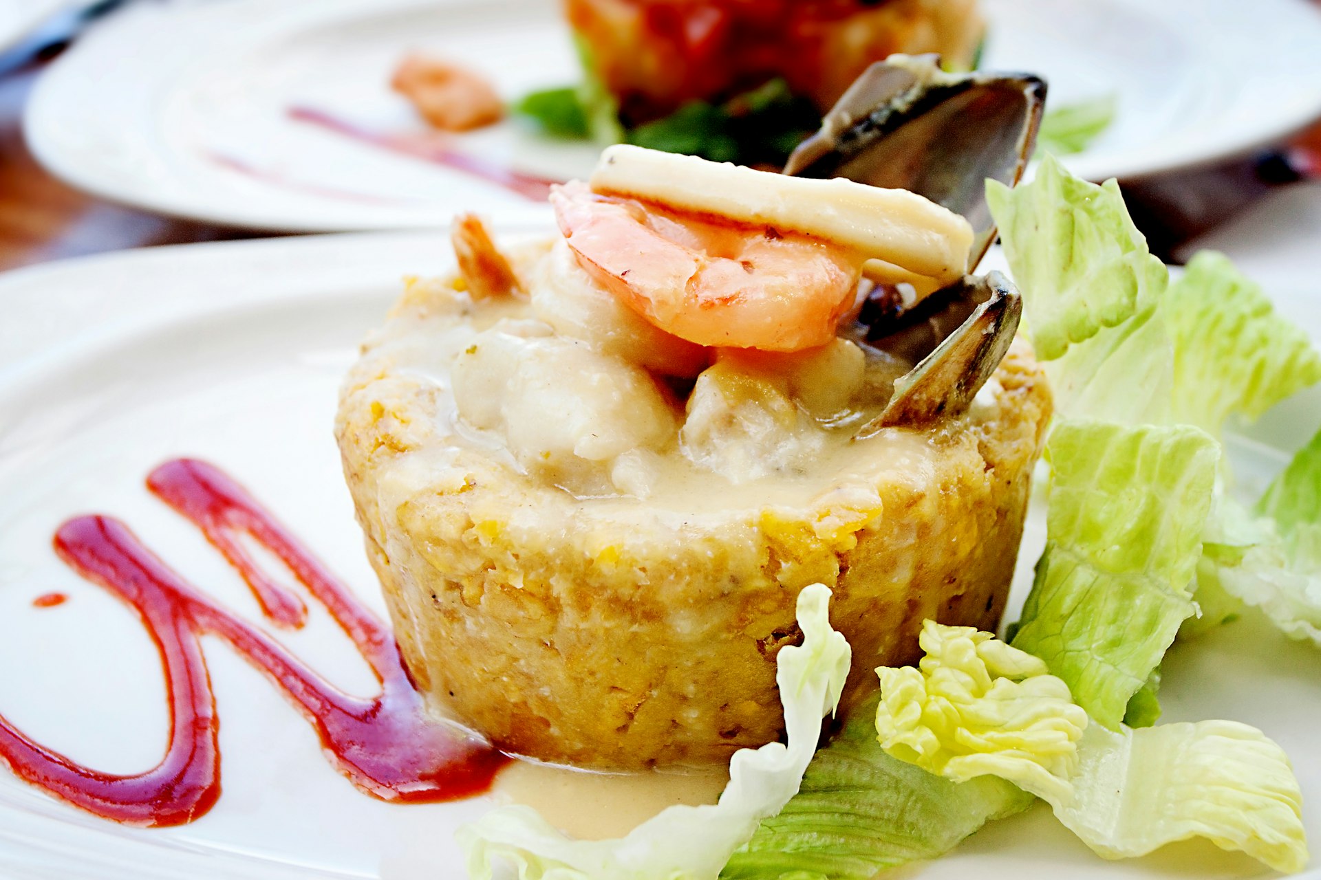 Closeup of a Puerto Rican dish - mofongo- which is comprised of mashed plantains topped with shrimp.