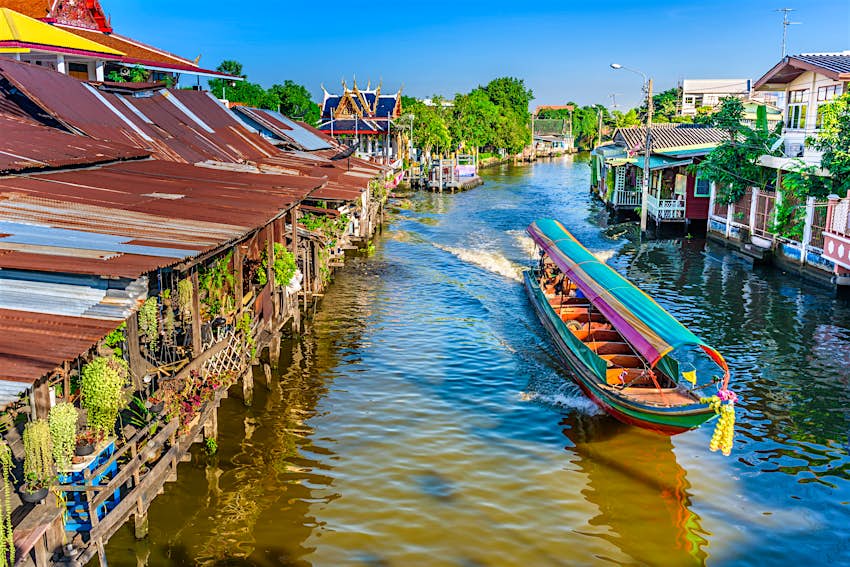 Boat traveling in a canal in Bangkok