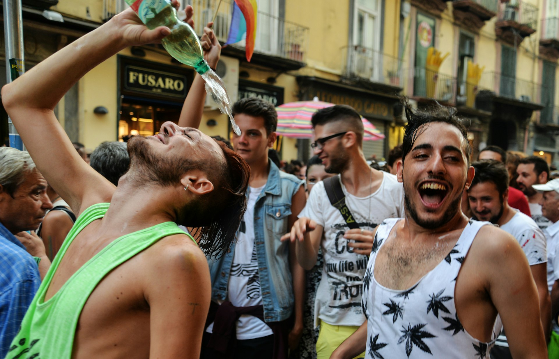 Men laughing and smiling as they celebrate the Gay Pride parade in Naples, Italy