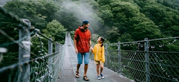 Happy father and his young daughter walking on bridge, Iya Valley, Tokushima, Shikoku, Japan