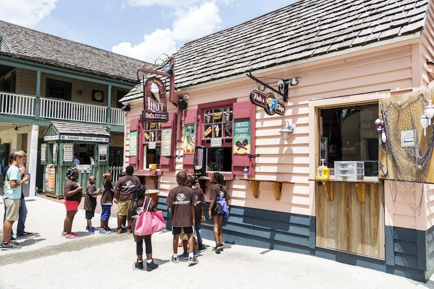 Kids line up outside a pink icecream shop
