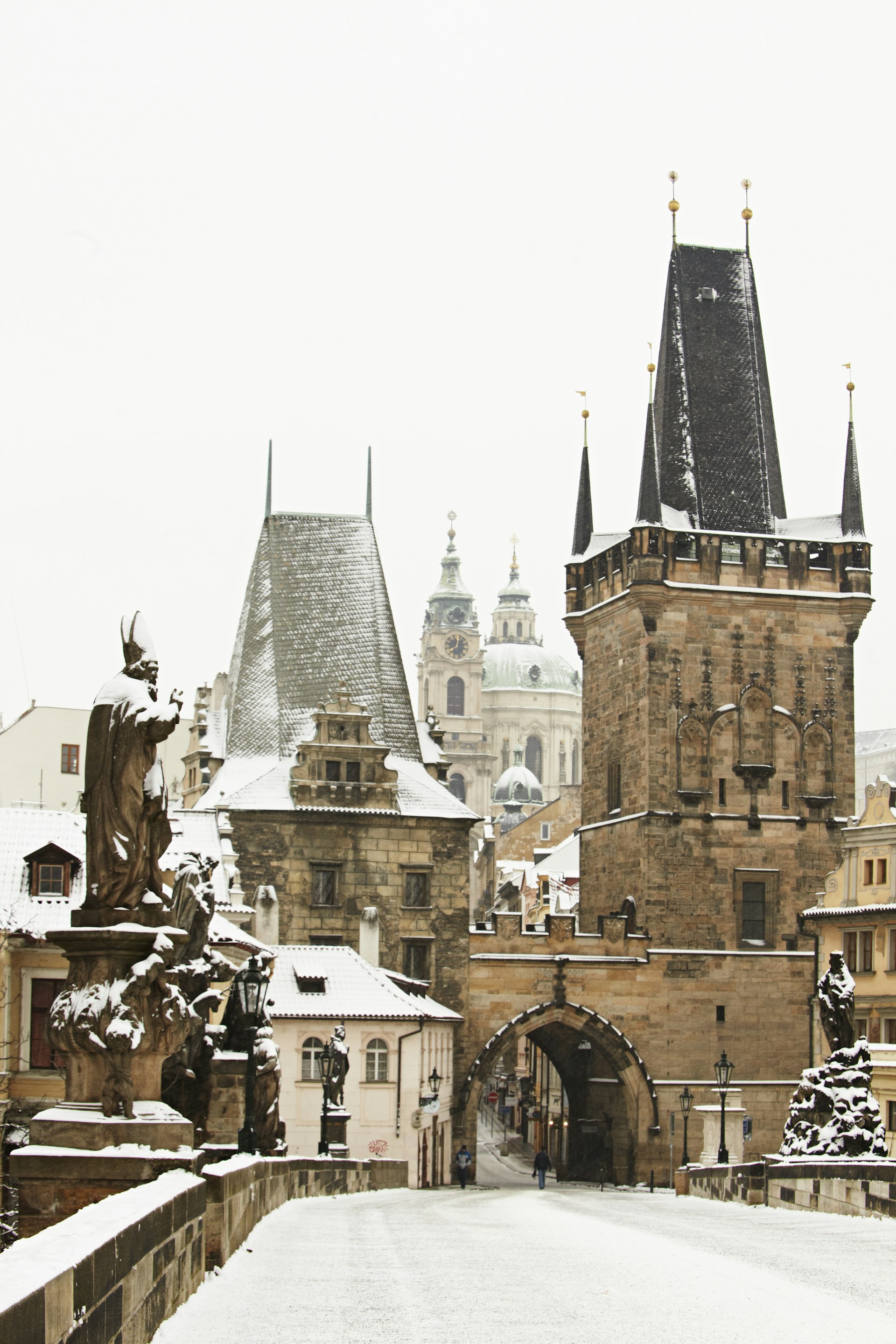 A view from the snow-covered Charles Bridge toward Malá Strana in Prague