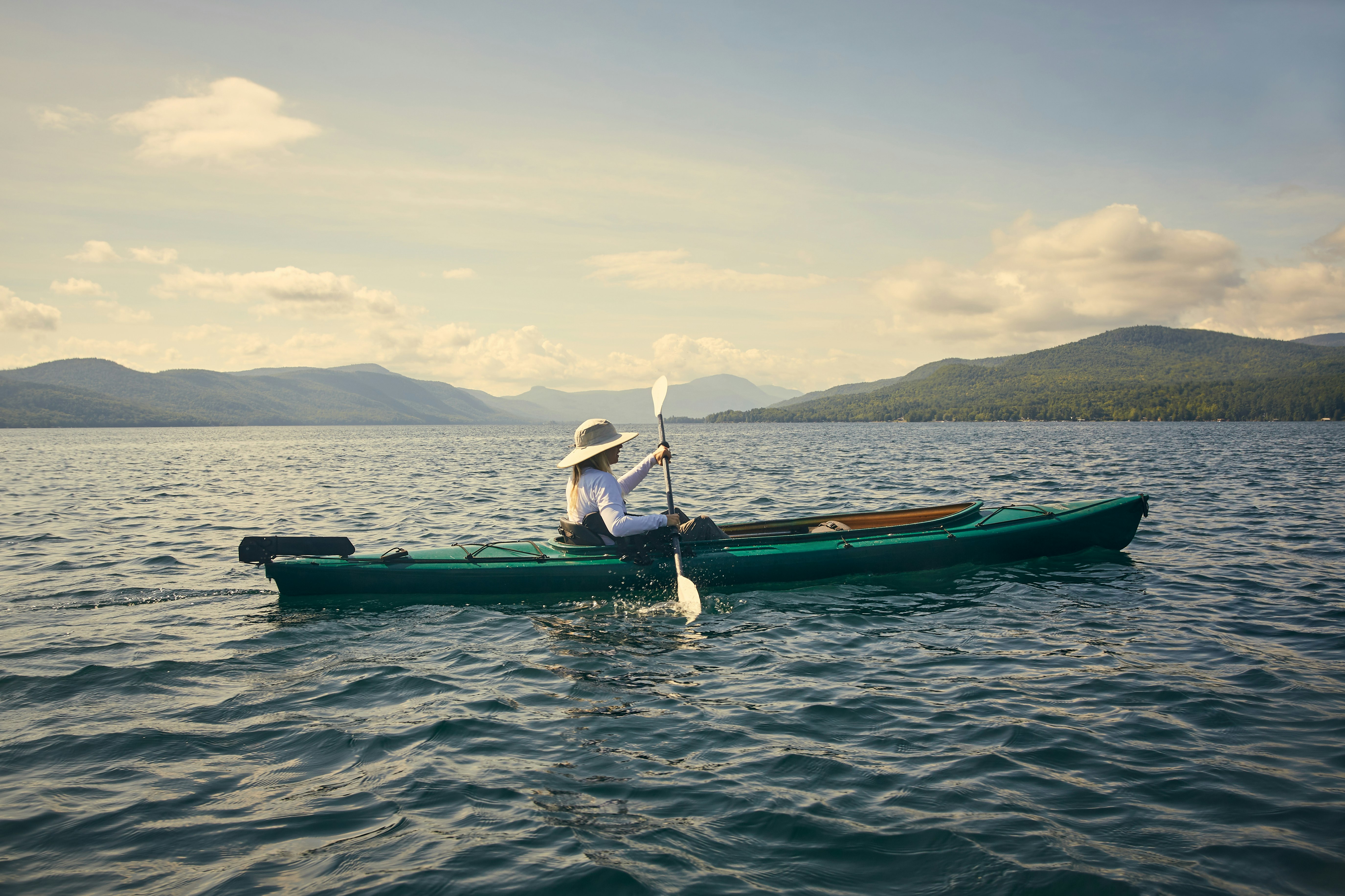 Woman paddling kayak, Adirondacks, Lake George, New York, United States