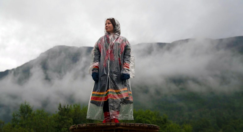 A woman stands amid the mist at Riddu Riddu Festival in Norway.