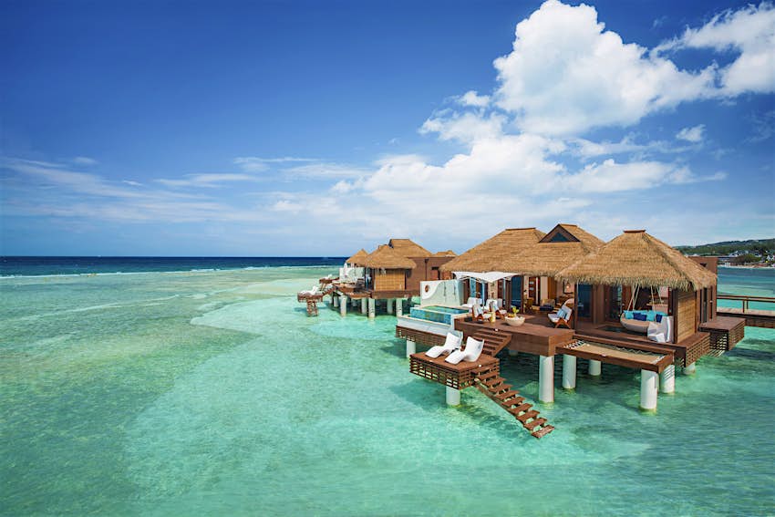 Clear, calm waters surround one of Sandals Royal Caribbean's overwater bungalows