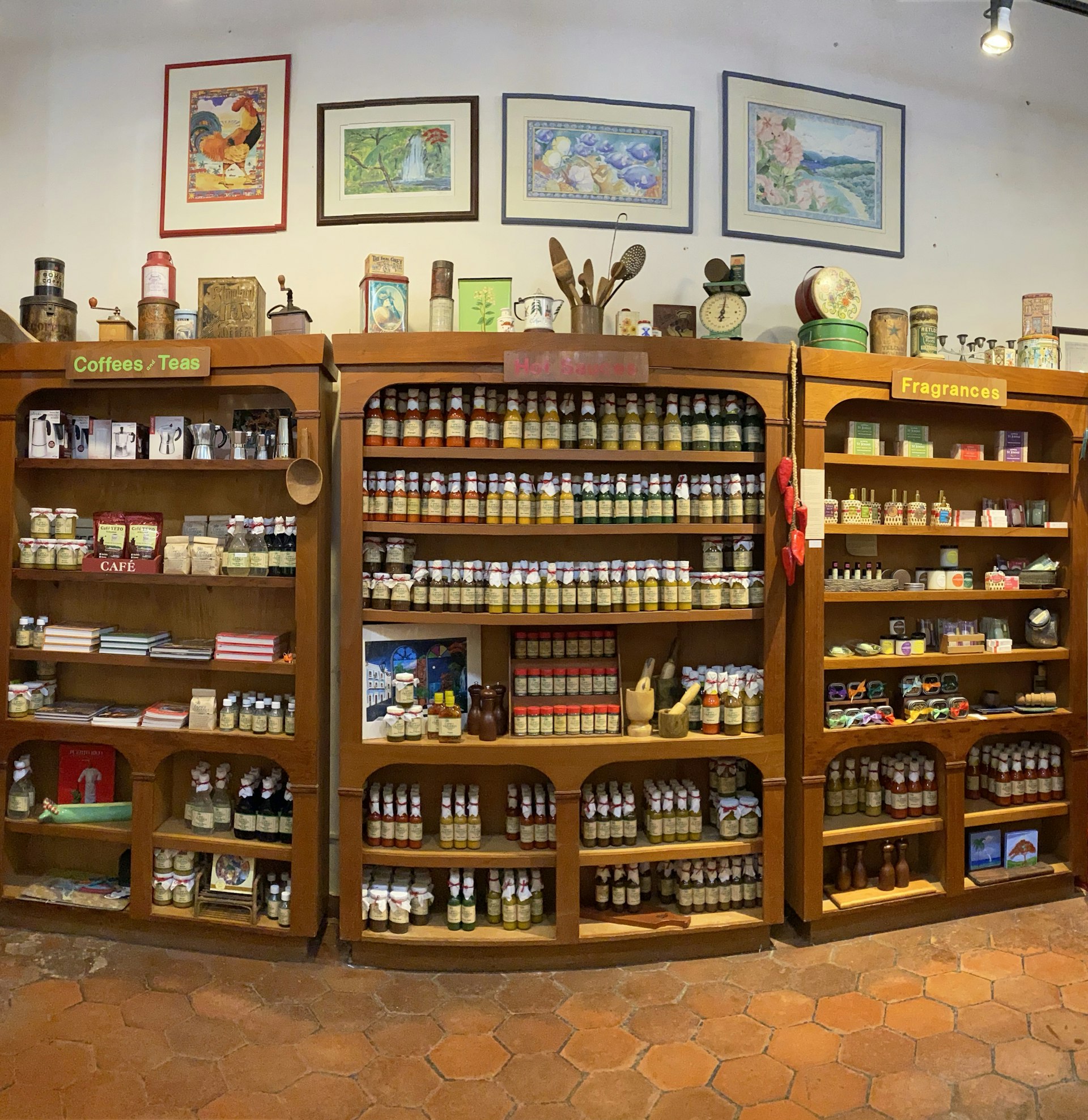Large wooden shelf filled with spices, sauces and jam in the Spicy Caribbee in San Juan Puerto Rico.