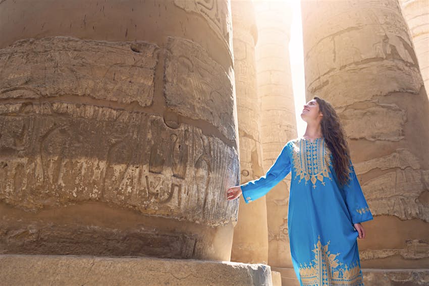 A woman visits the Great Temple of Amun in Karnak, Egypt.