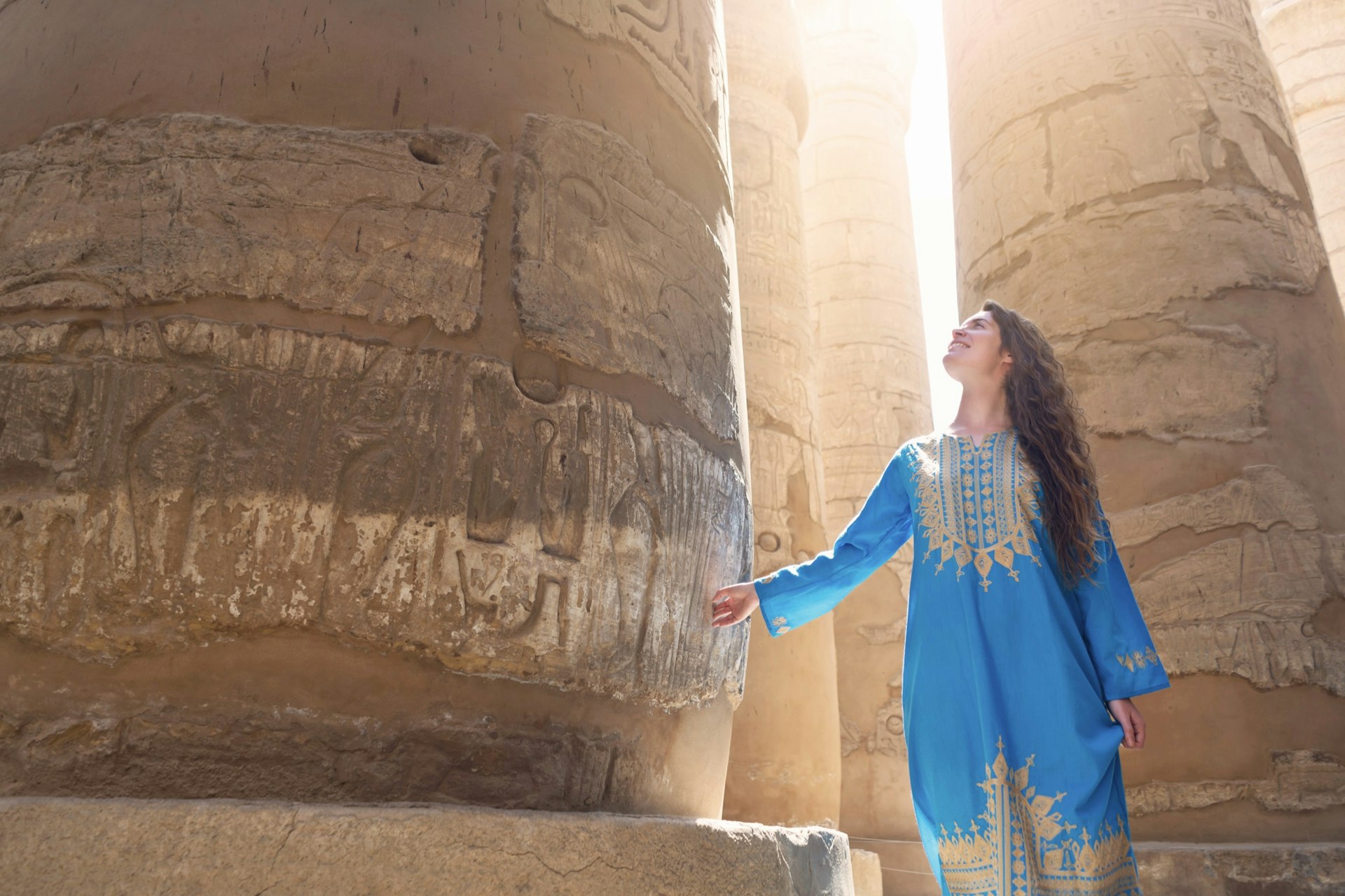 A woman tours the Great Temple of Amun in Karnak, Egypt.