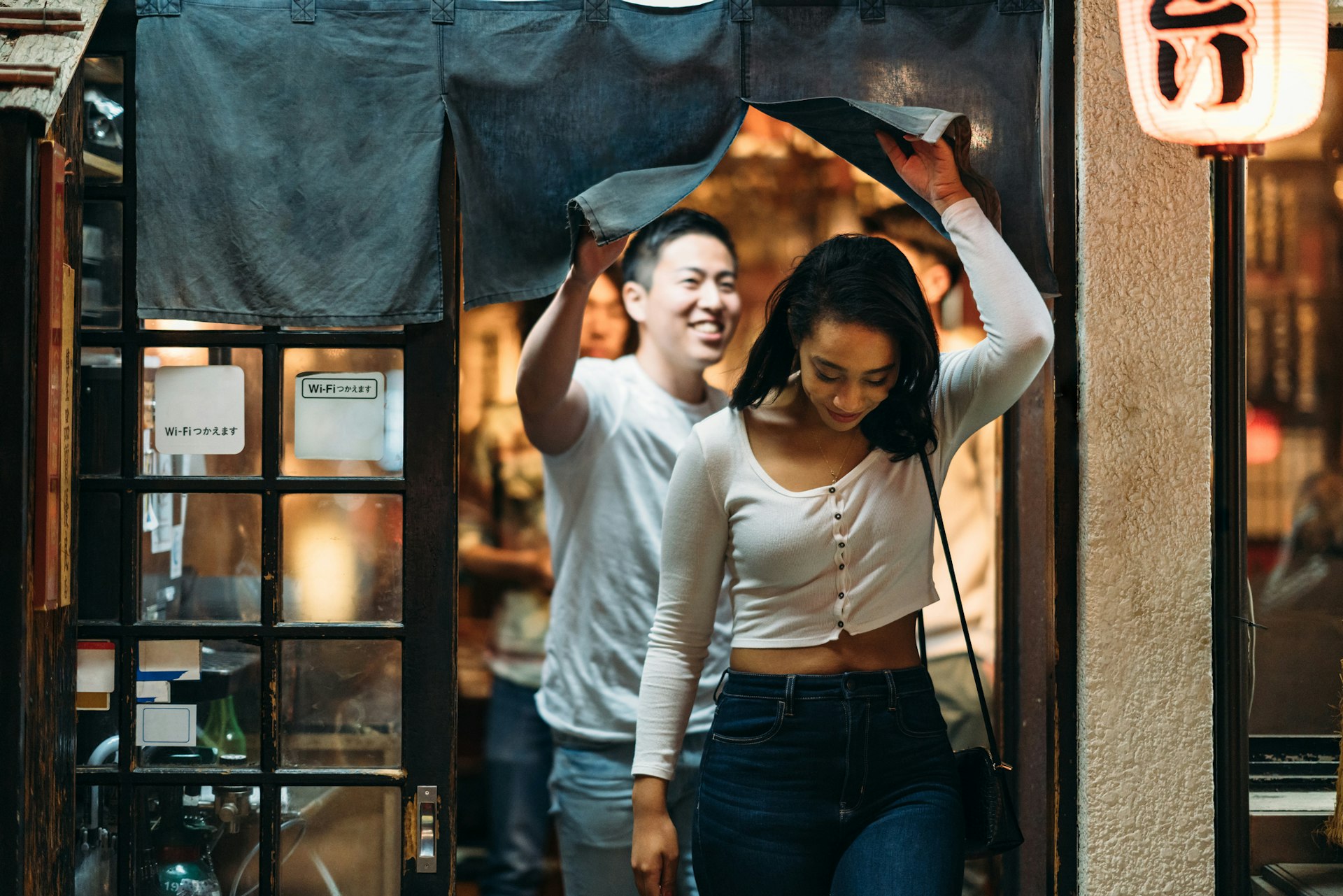 Young couple leaving restaurant in Tokyo