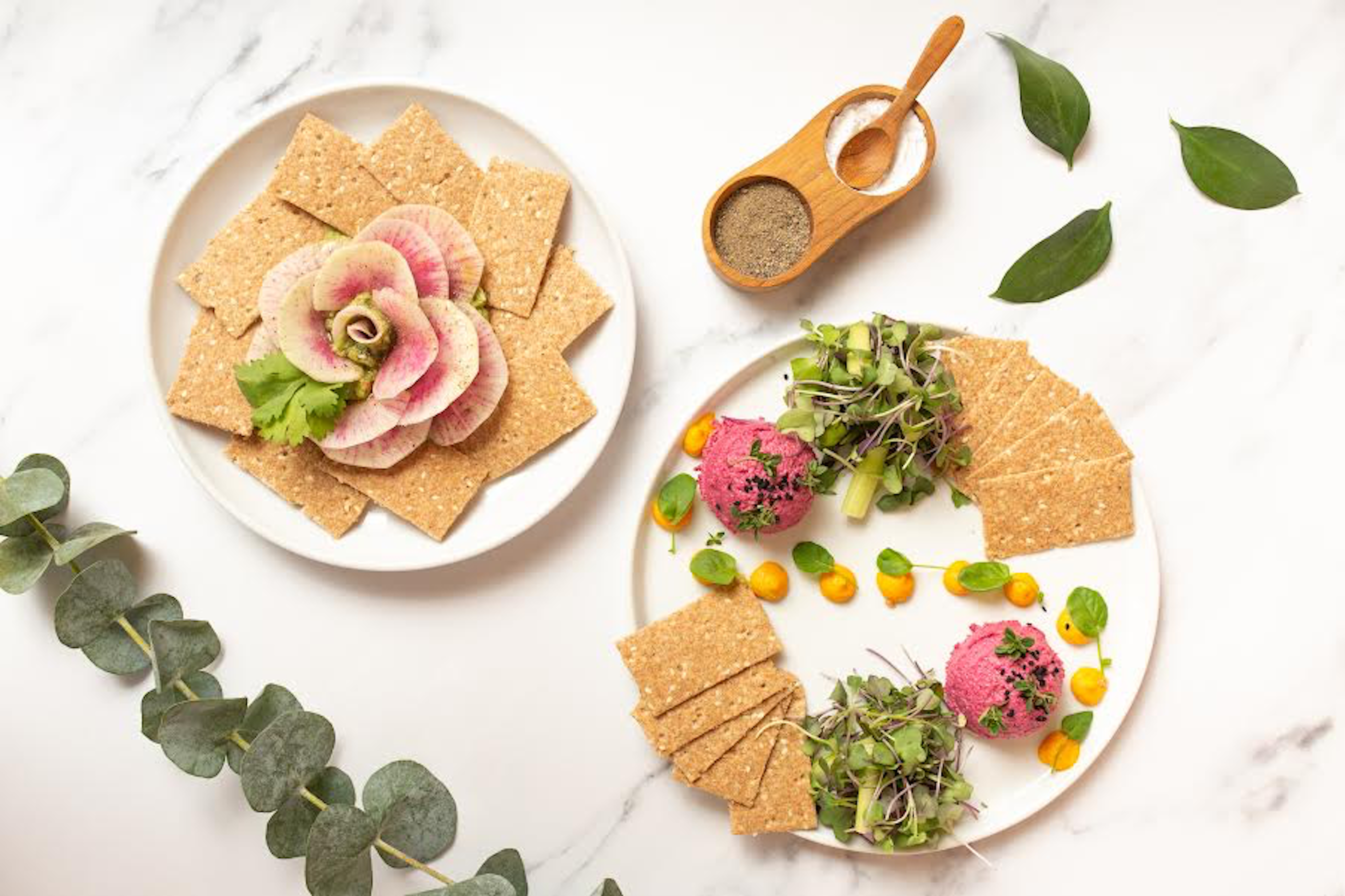 Divya's avocado dip next to sunflower beet hummus with roasted carrot tahini