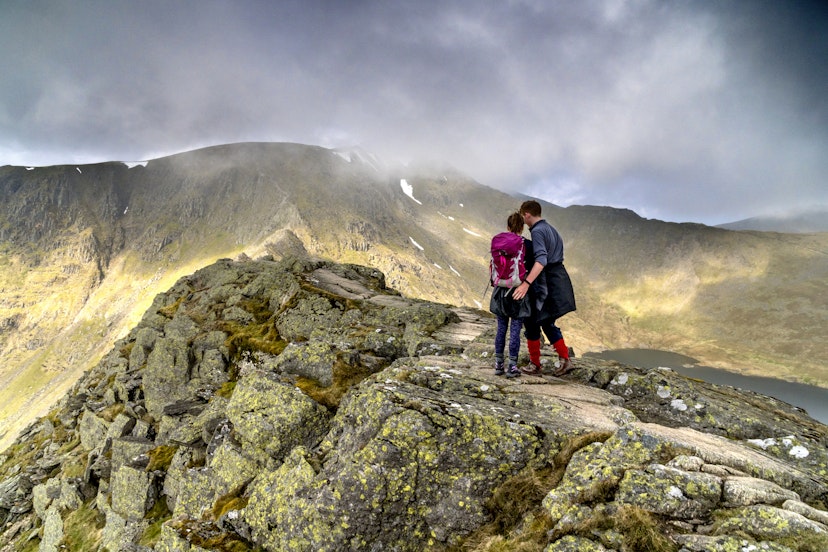 Young hikers on Striding Edge and Helvellyn in the Lake District national park - stock photo
