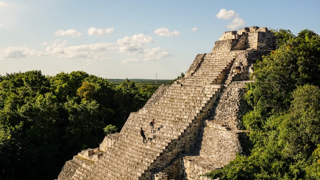 People use ropes to scale the stairs at the Becan Maya Ruins.