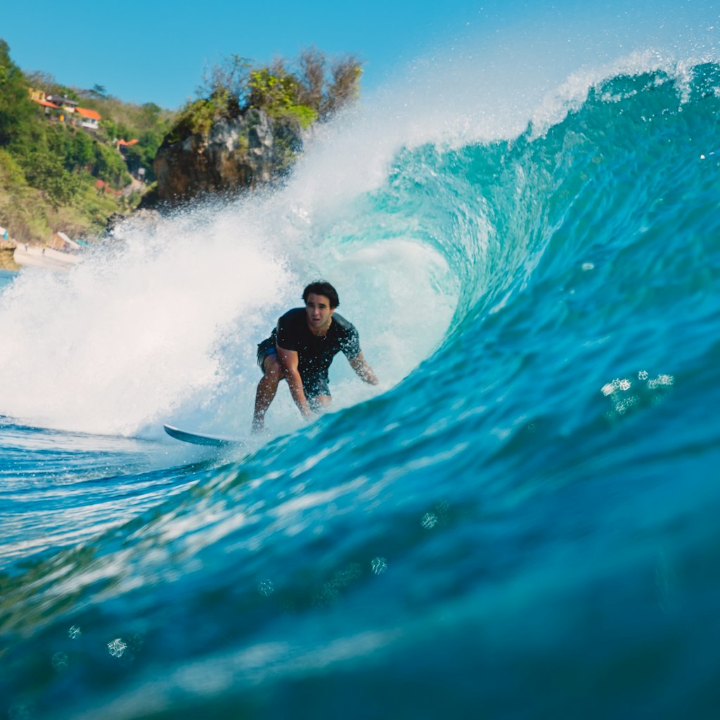 July 7, 2018: A male surfer inside the barrel of a wave at Padang Padang.