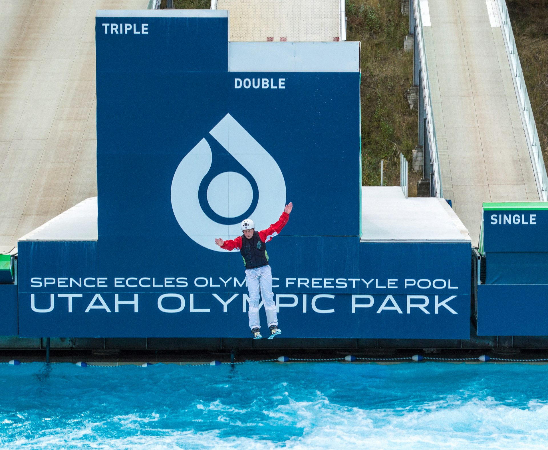 A freestyle skier about to land in a pool after a practice run down a ski ramp at Utah Olympic Park