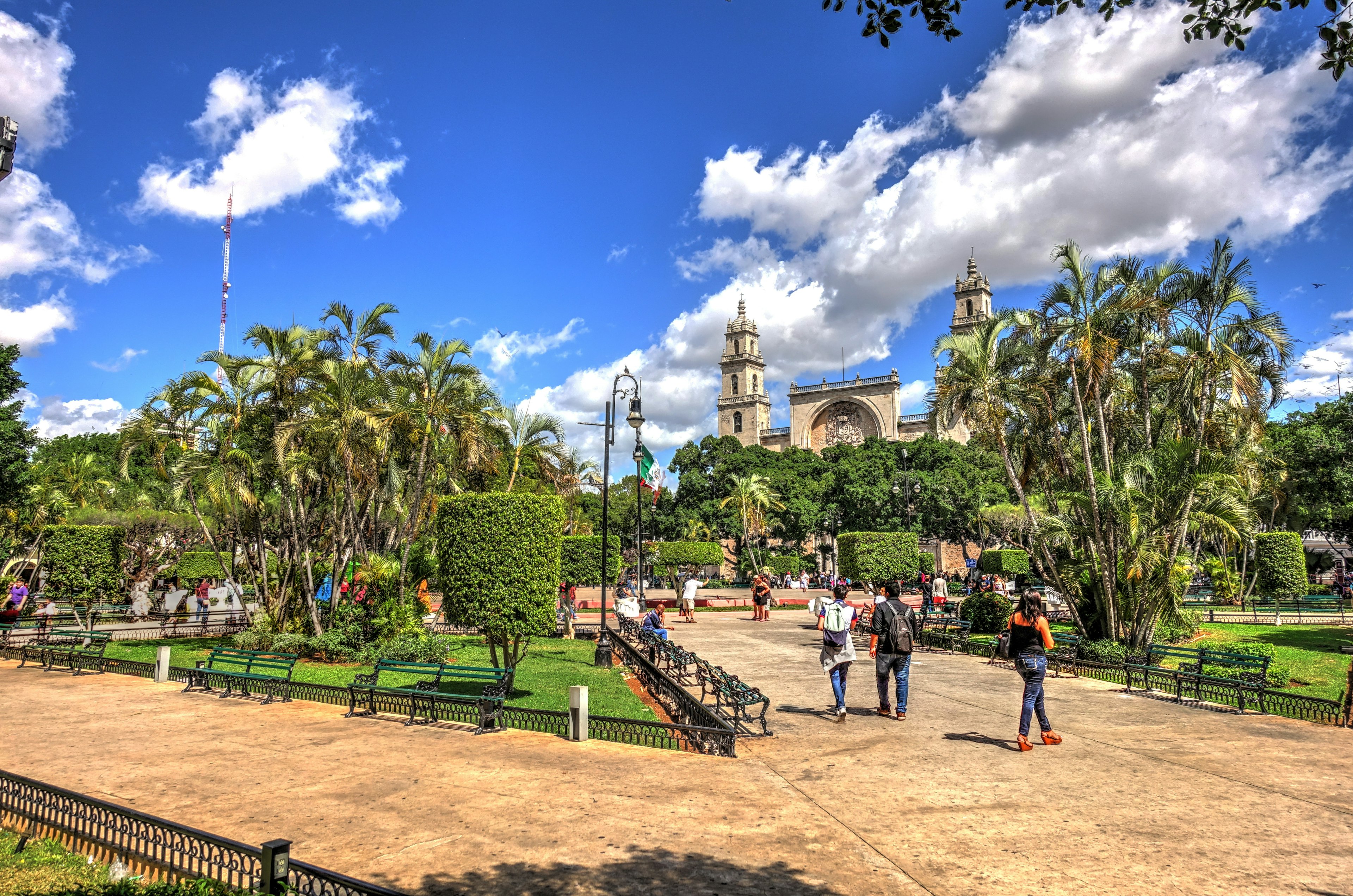 People walking through Merída's historic center on a sunny day