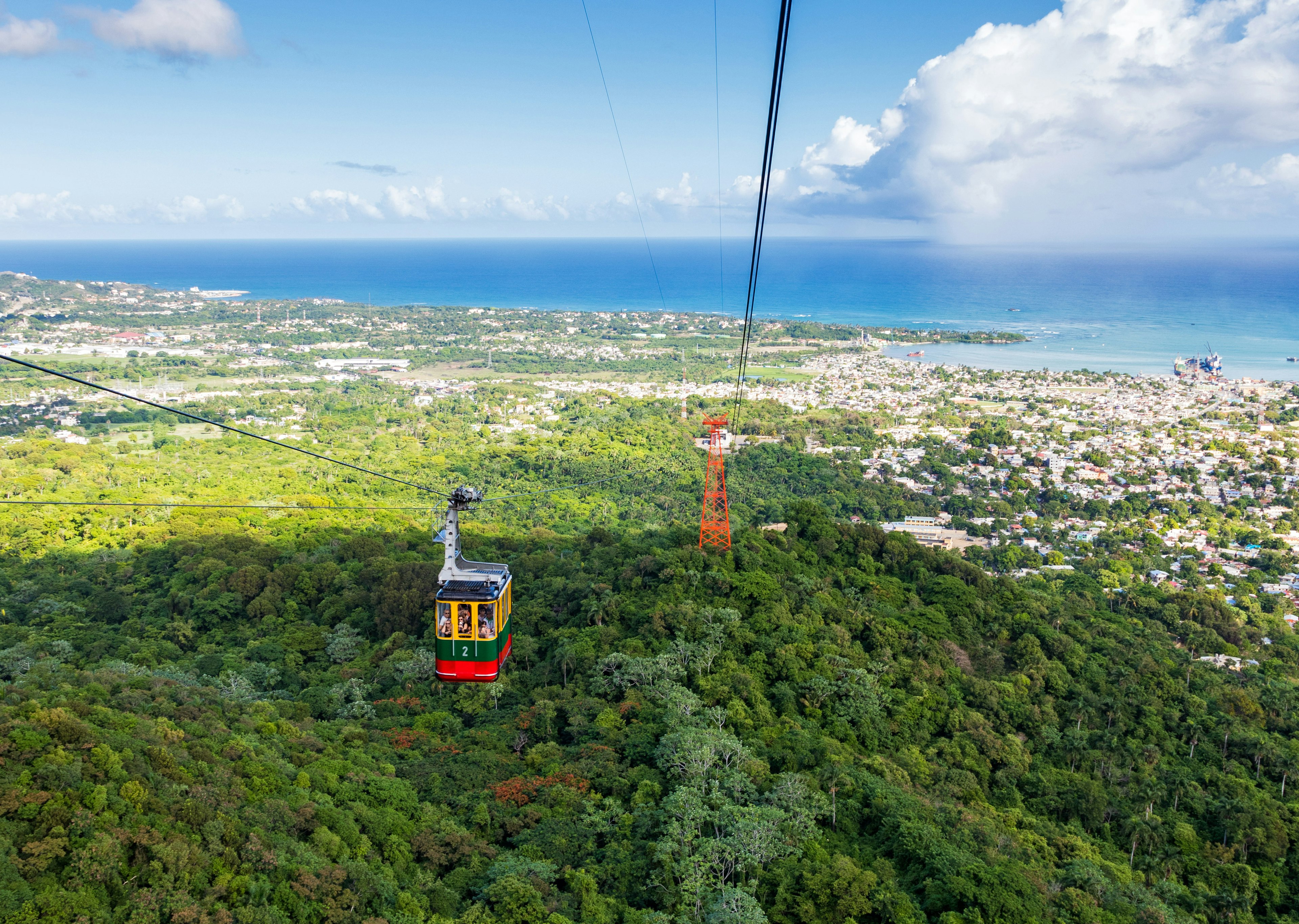 A cable car tours above a forest area in Puerto Plata