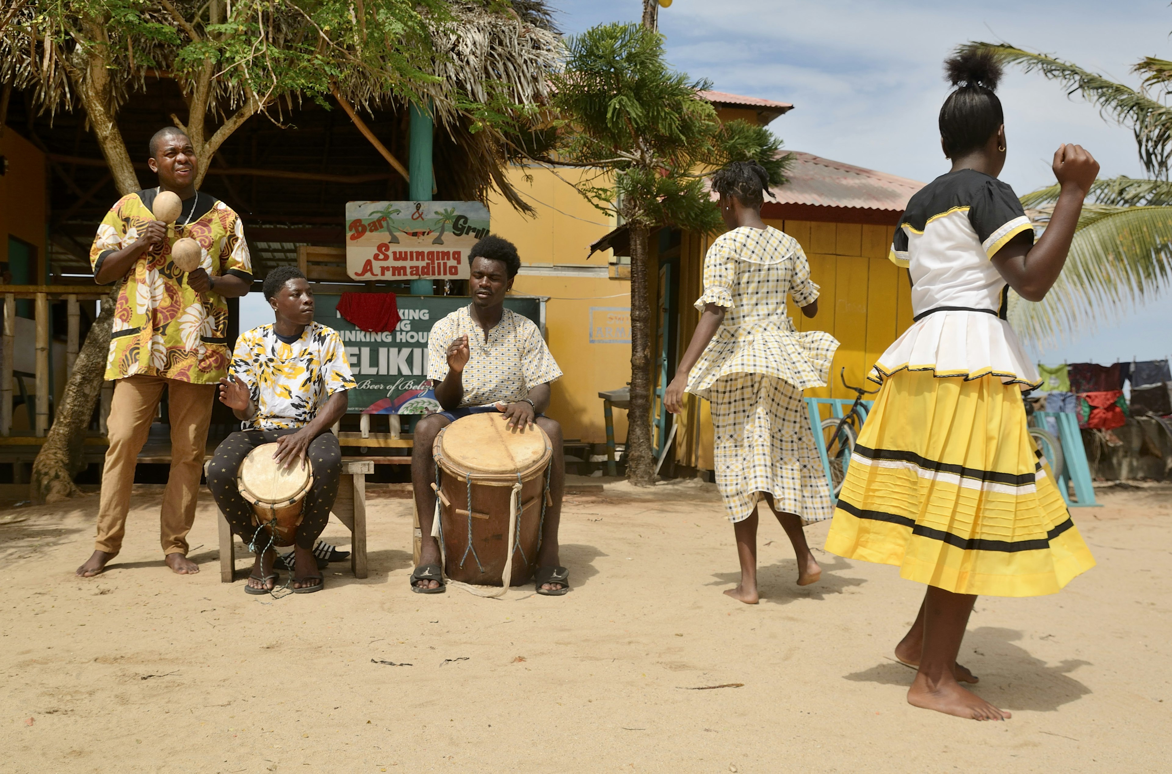 A Garifuna troupe performs traditional songs with drumming and dancing in Hopkins village