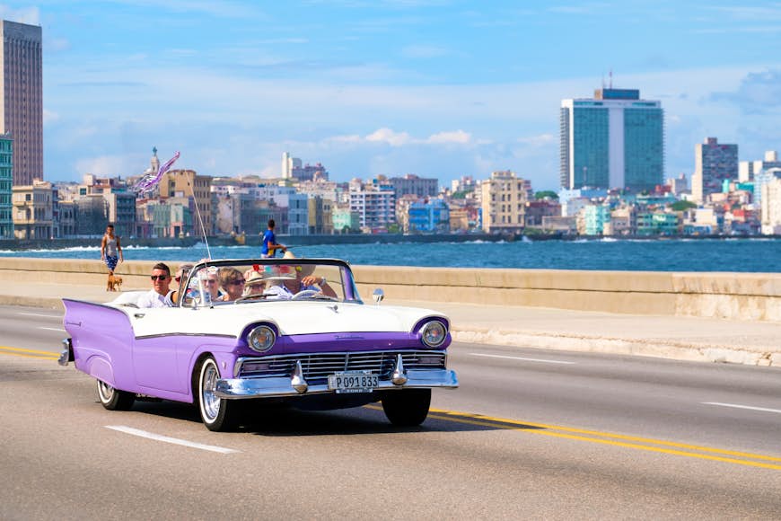 A classic car on the seafront in Havana