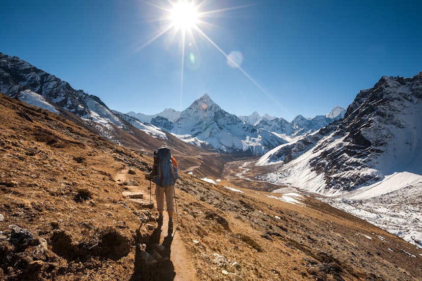 Trekker in Khumbu valley in front of Mt Abadablan, on the way to Everest Base camp.