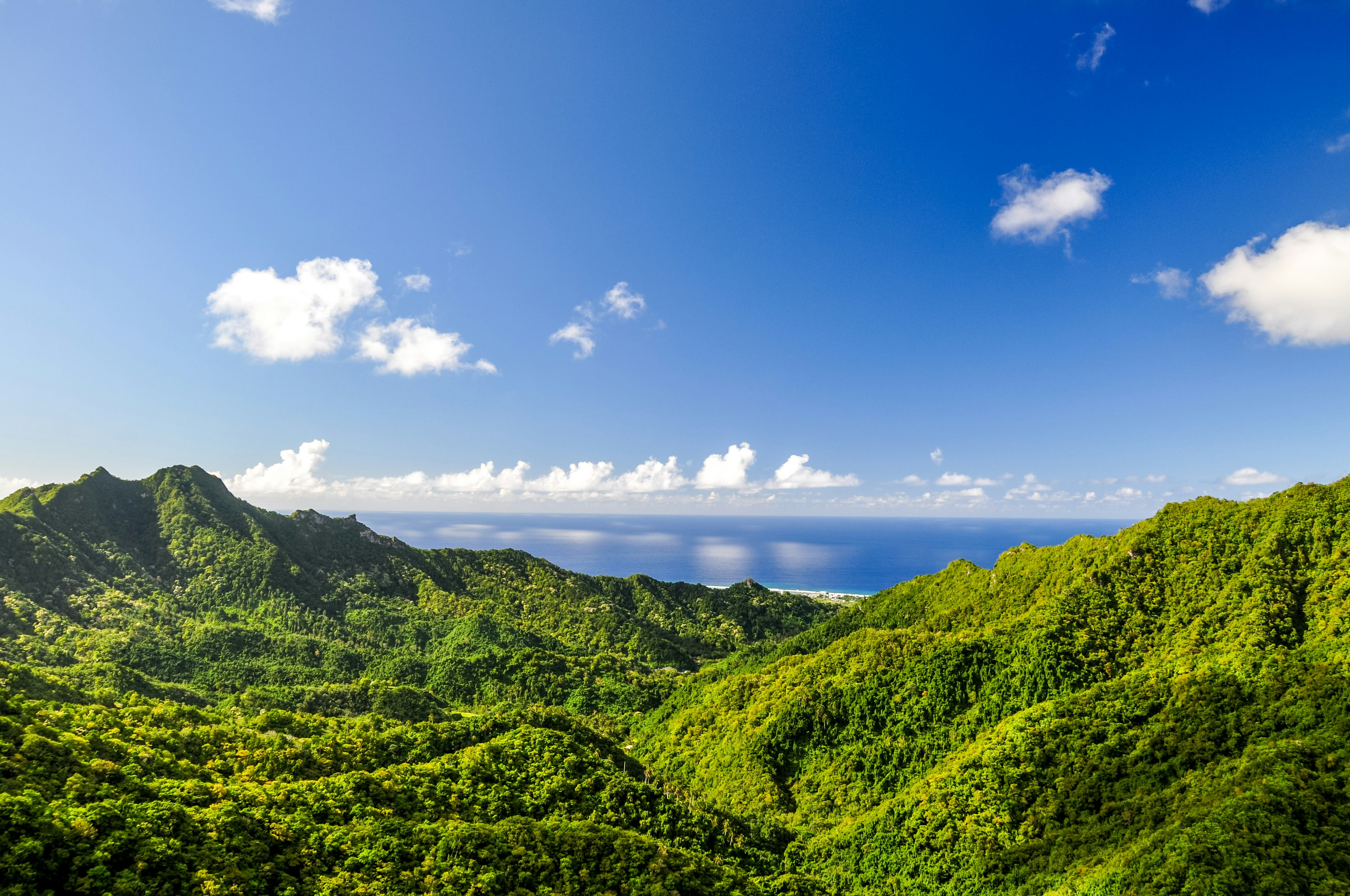 Views over Rarotonga from the Needle, with green ridges dropping to the sea