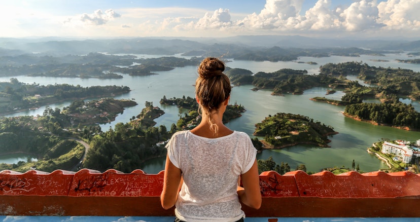 A girl looks over Guatape and the expansive lake system.