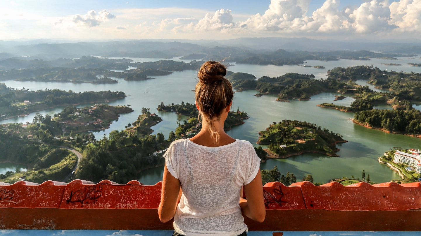 A girl looks over Guatape and the expansive lake system.