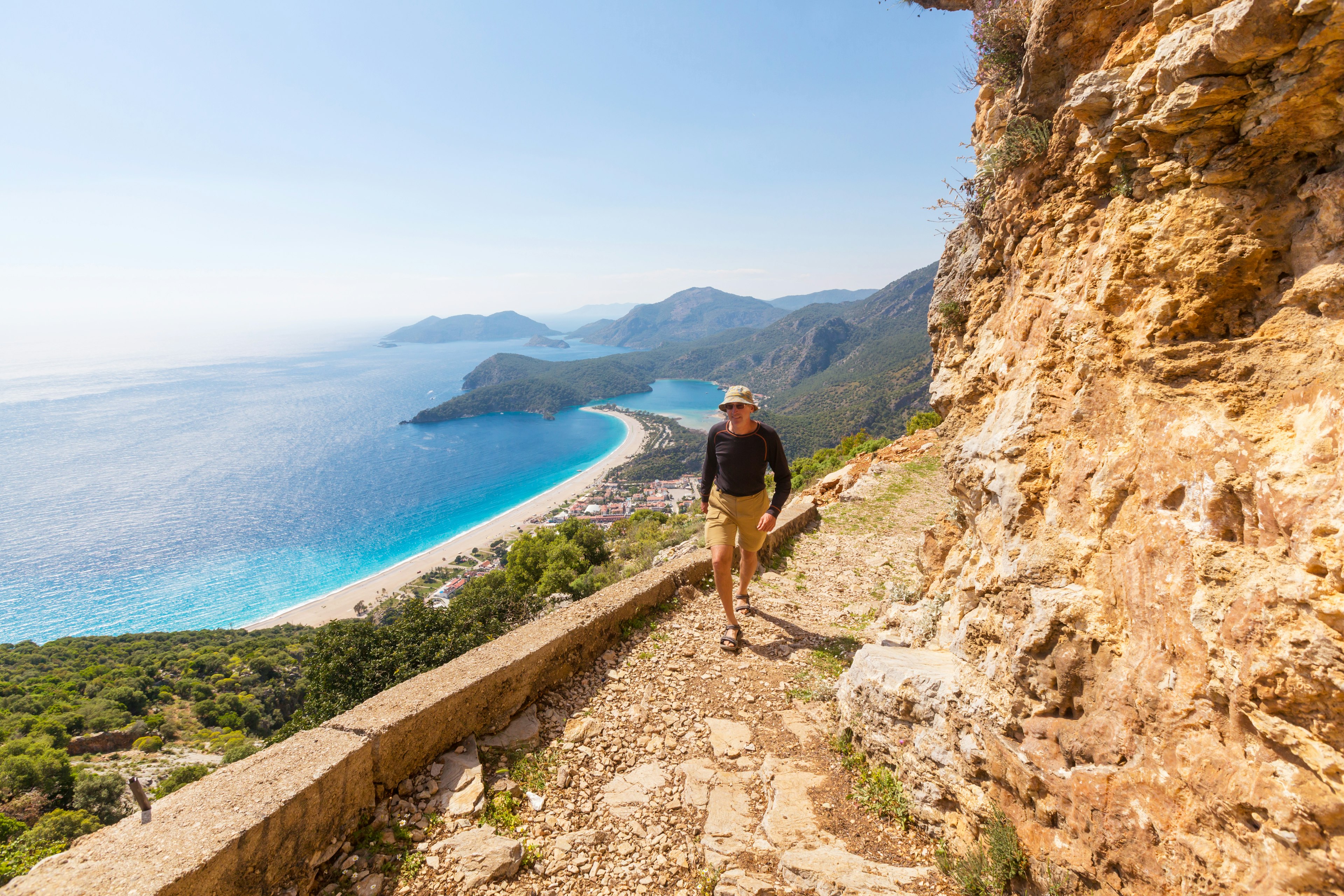 A hiker on famous Lycian Way in the Turkey in front of a sea view