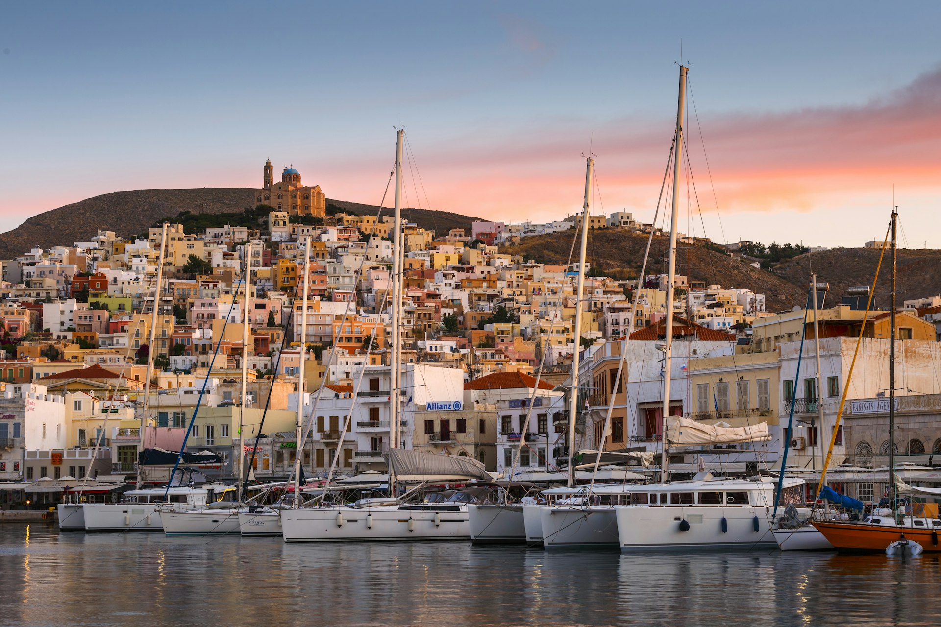 Ermoupoli town on Syros island in Greece with sailing boats docked in the bay