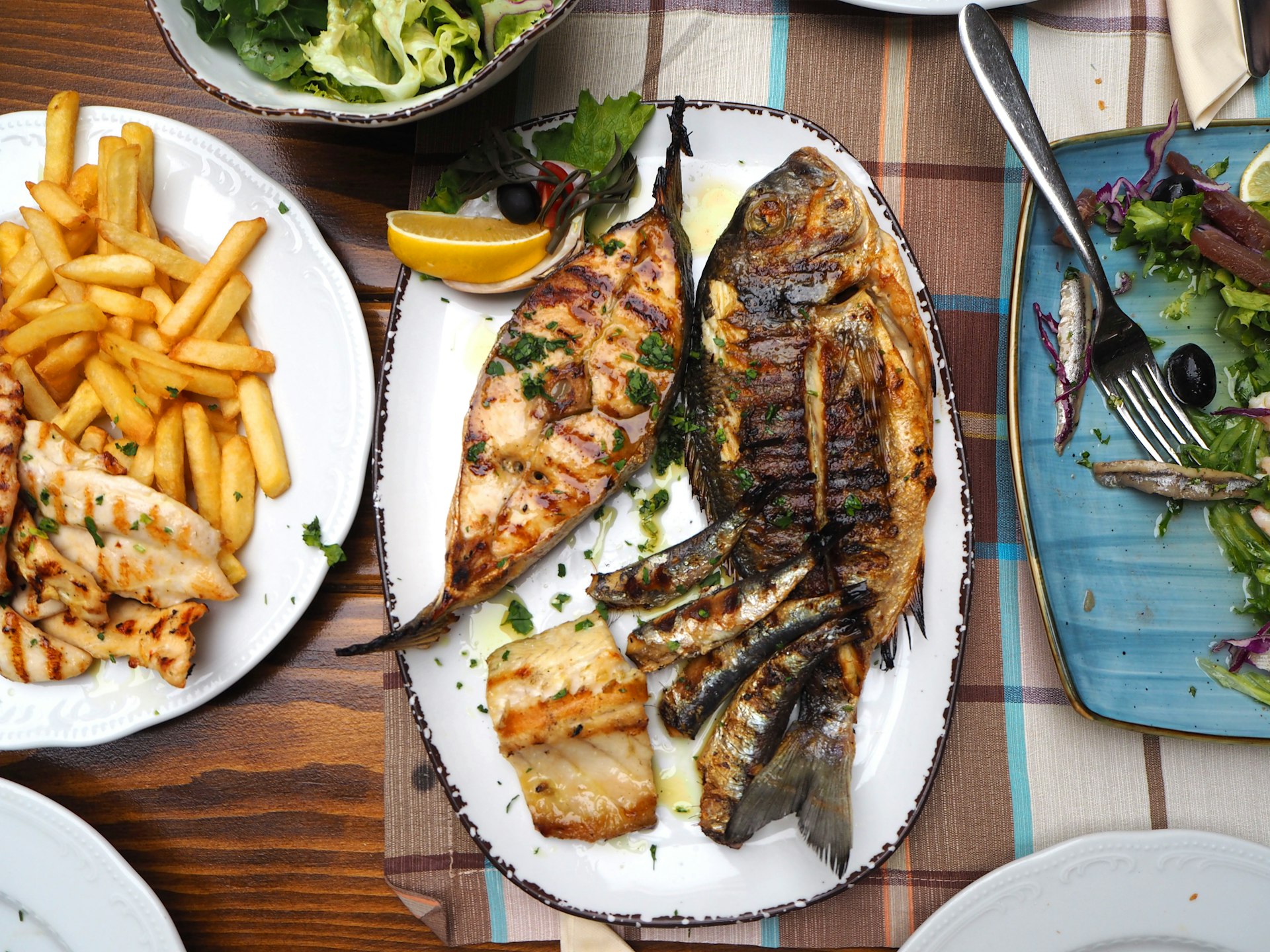Plate of grilled fish, chips and salad in Dubrovnik