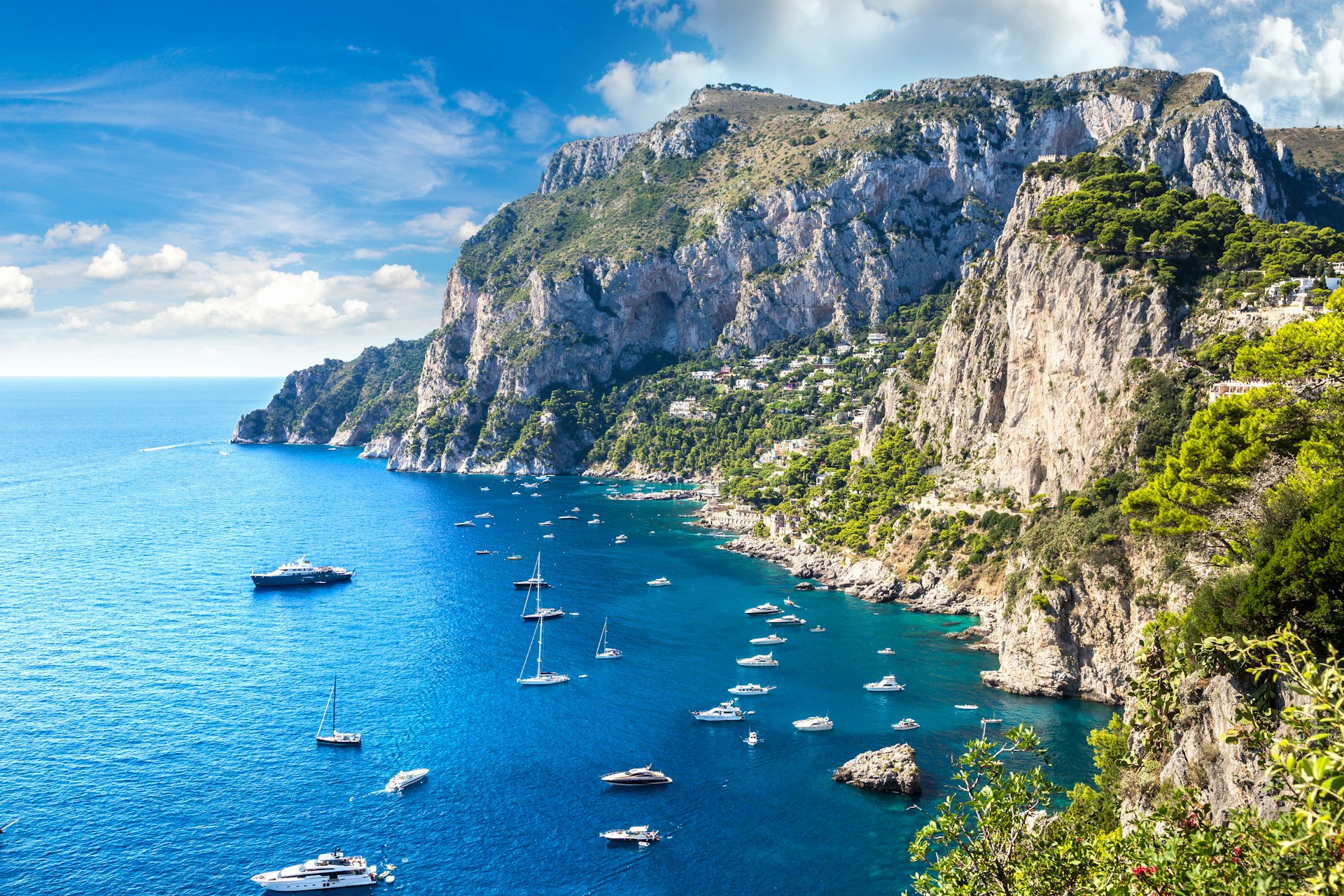 Sailing boats in a sunny bay in Capri