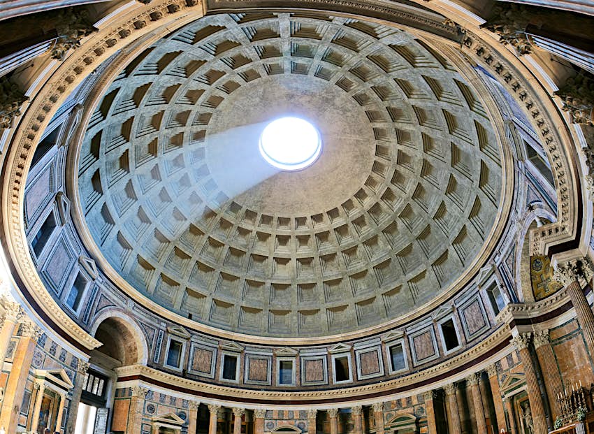 A beam of light shines through the oculus of the dome at the Pantheon, in Rome