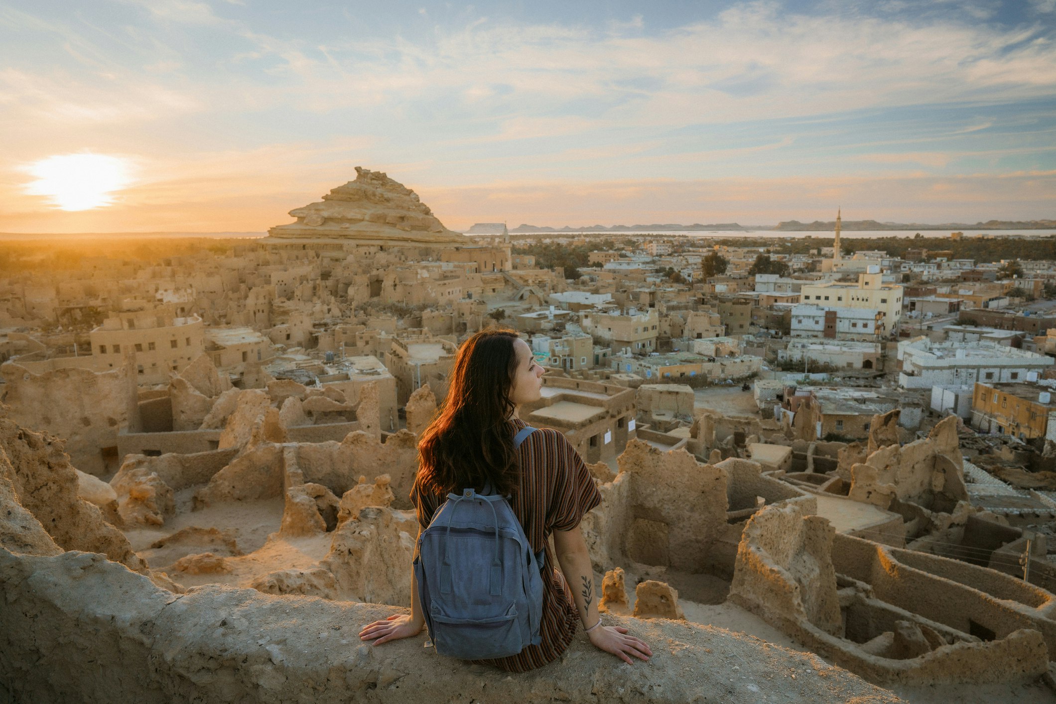 Woman looking at scenic view of Siwa oasis at sunset