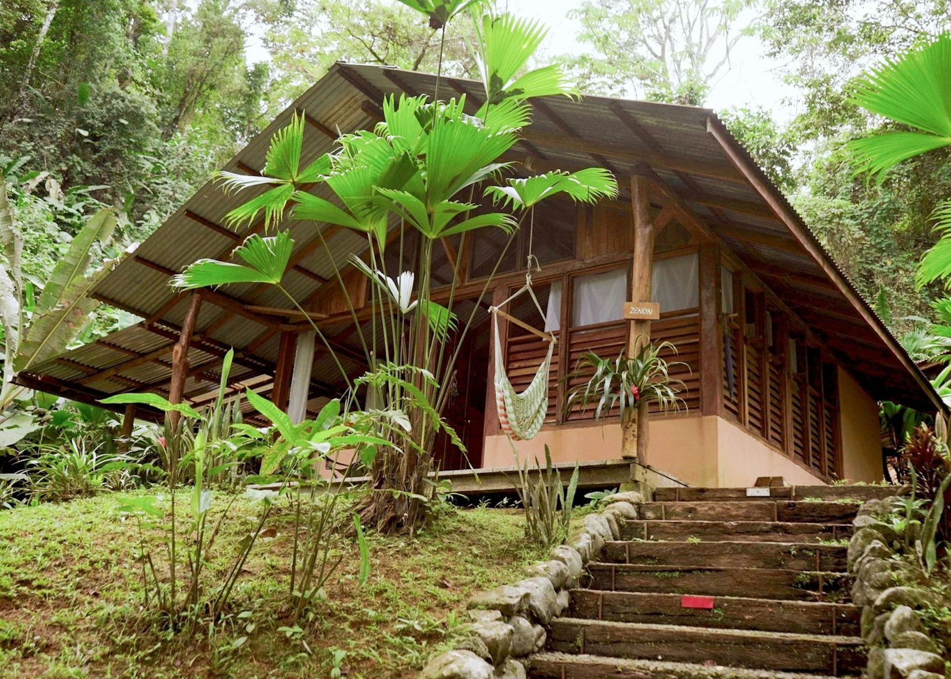 Exterior shot of the wooden Amazonita Ecolodge surrounded by trees in Costa Rica 