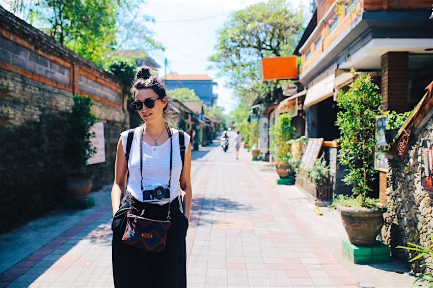 young traveler in Ubud, Bali, Indonesia Young woman, solo tourist, walking the streets in Ubud