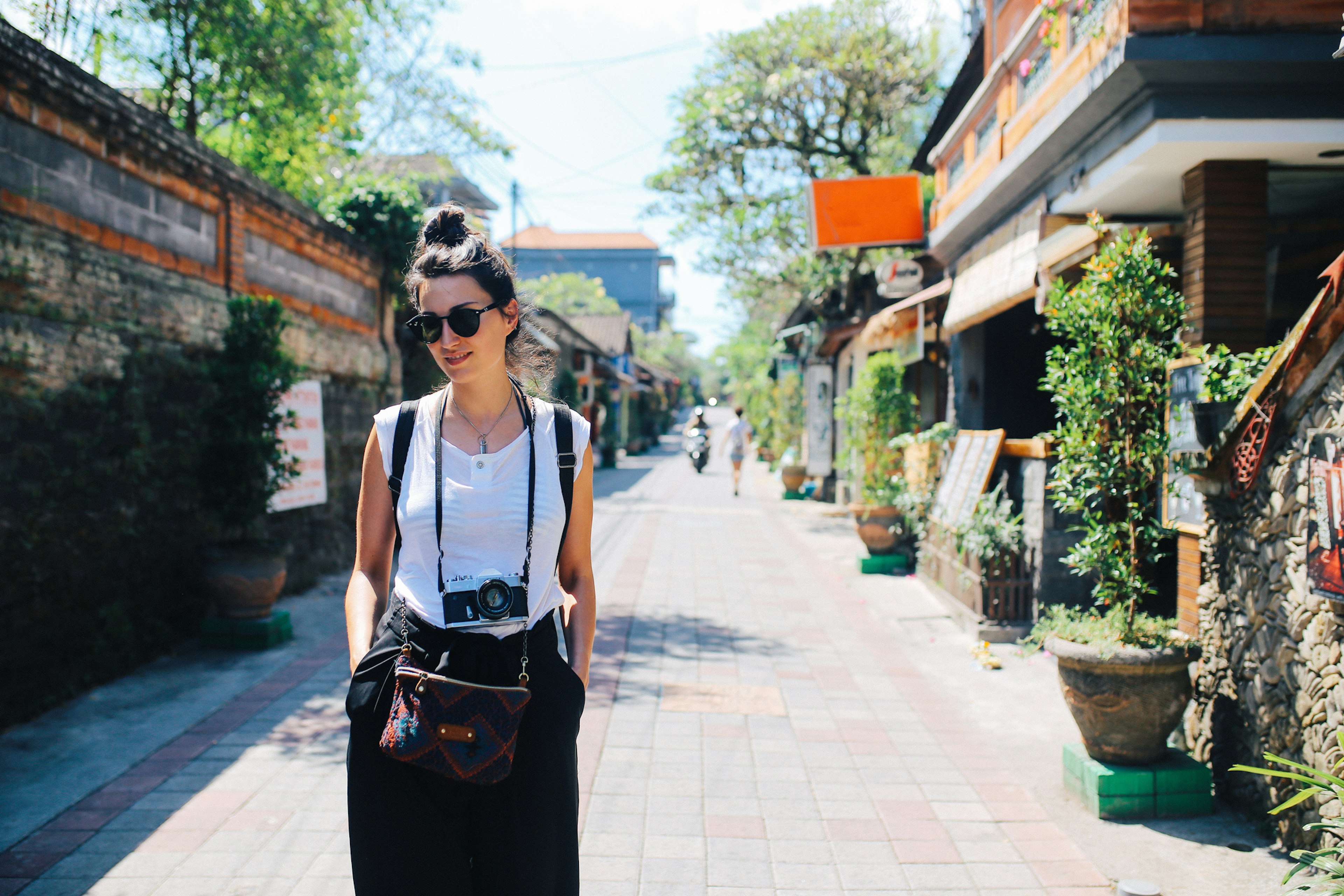 Young woman, solo tourist, walking the streets in Ubud