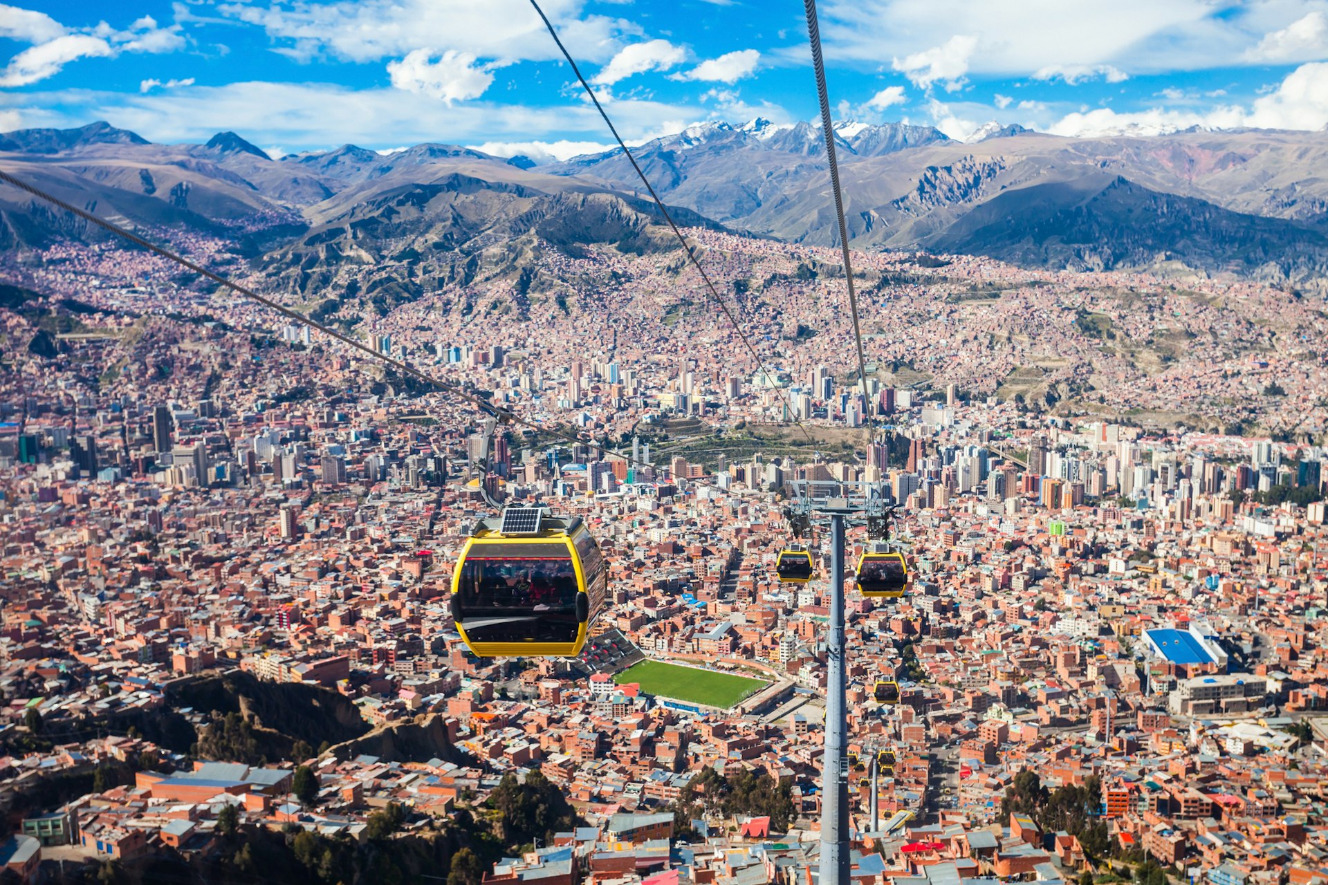 A cable car rises above a city densely packed with buildings