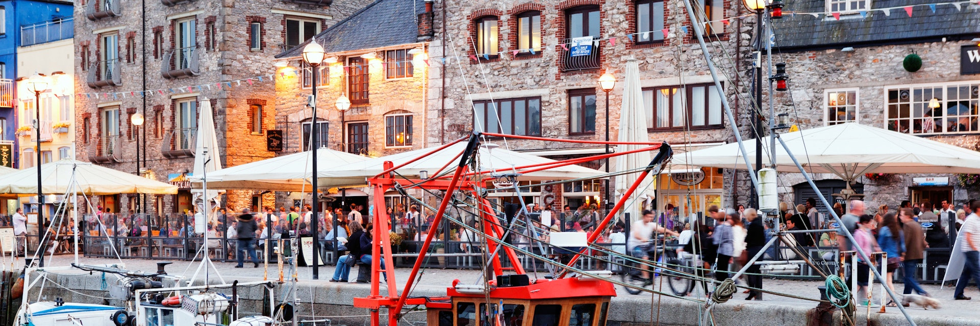 Fishing vessels and terraces of Pubs and restaurants, Barbican, Old harbour, Plymouth, Devon - stock photo