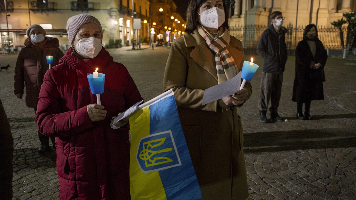 POMPEI, ITALY - FEBRUARY 24: The Ukrainian community during a torchlight procession in solidarity with the Ukrainian people in front of the facade of the sanctuary of Pompeii, Southern Italy on February 24, 2022. (Photo by Alessio Paduano/Anadolu Agency via Getty Images)
