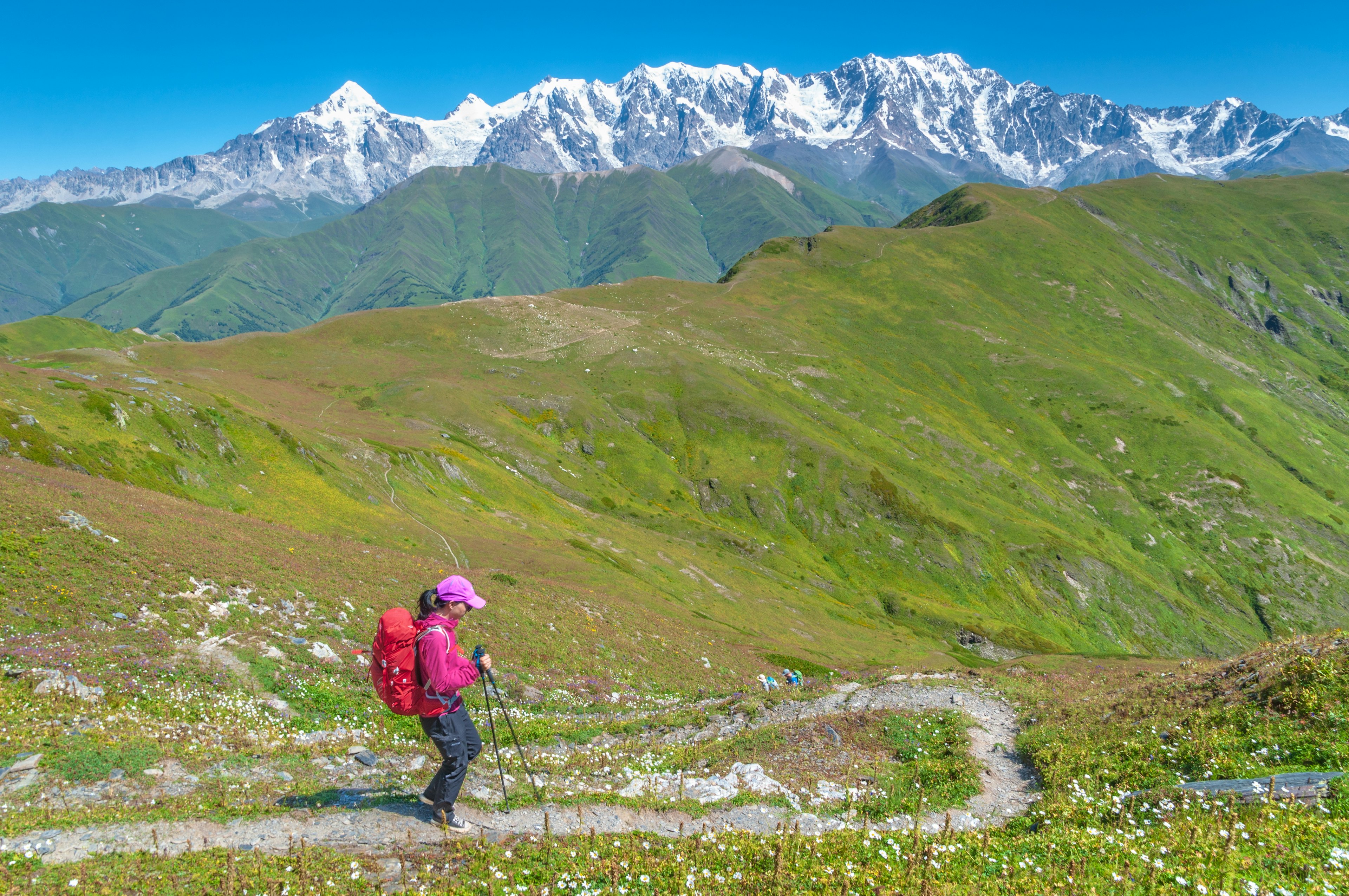 Female hiker descending from Latpari Pass in northern Georgia