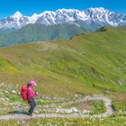 Female hiker descending from Latpari Pass in northern Georgia