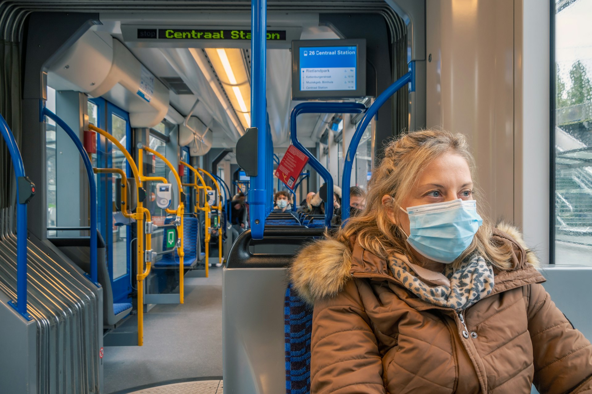 A woman with a facemask on public transportation  