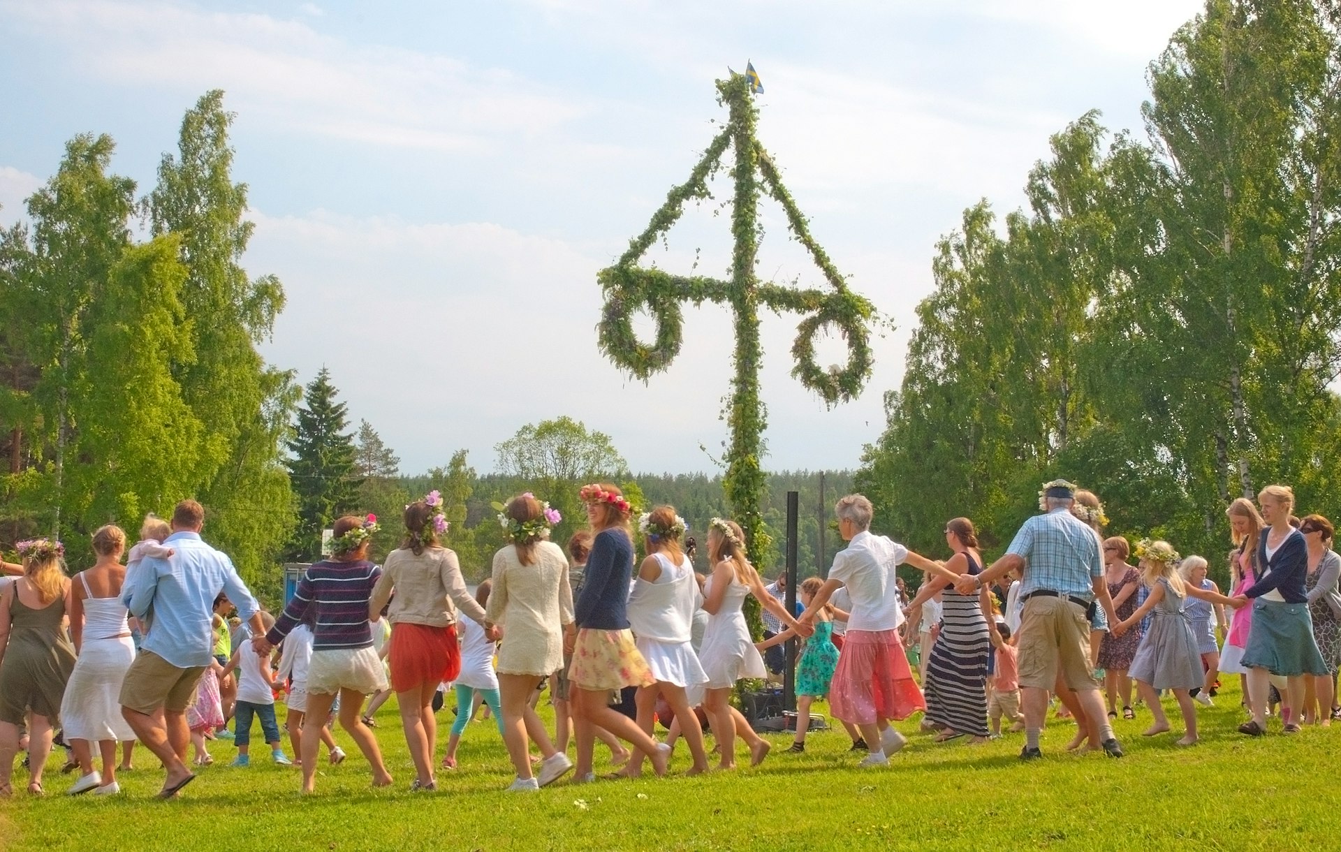 People dancing around a Midsummer pole at Summer Solstice in Akersberga