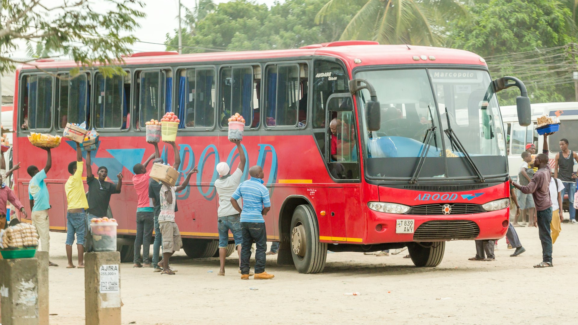 Street vendors surround a bus in Dar Es Salaam, Tanzania