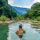 Woman swimming in river Guatemala