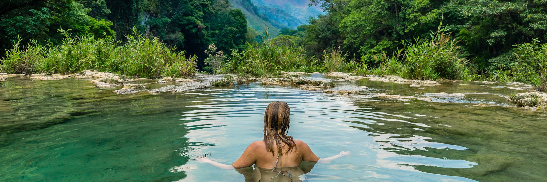 Woman swimming in river Guatemala