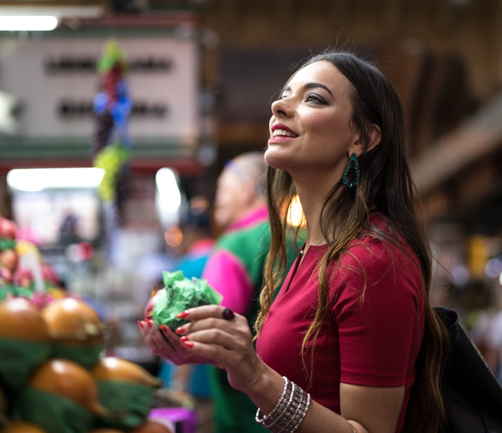 Woman shops in an outdoor market.