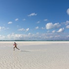 A girl running on a sandbar Stocking Island, Exumas, Bahamas