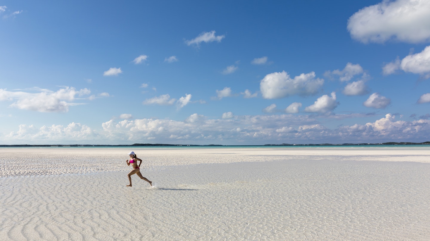 A girl running on a sandbar Stocking Island, Exumas, Bahamas