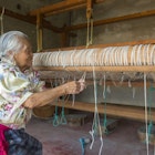 MEXICO - 2018/04/13: An old Zapotek woman is preparing a loom for weaving a carpet at a weavers home studio in Teotitlan del Valle, a small town in the Valles Centrales Region near Oaxaca, southern Mexico. (Photo by Wolfgang Kaehler/LightRocket via Getty Images)