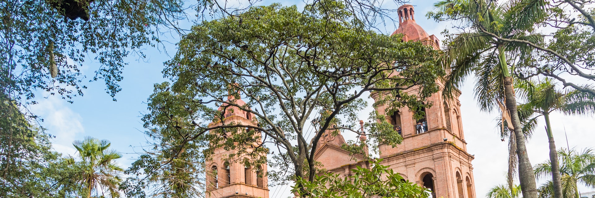 People relax in front of the Cathedral Basilica of St Lawrence in Santa Cruz, Bolivia